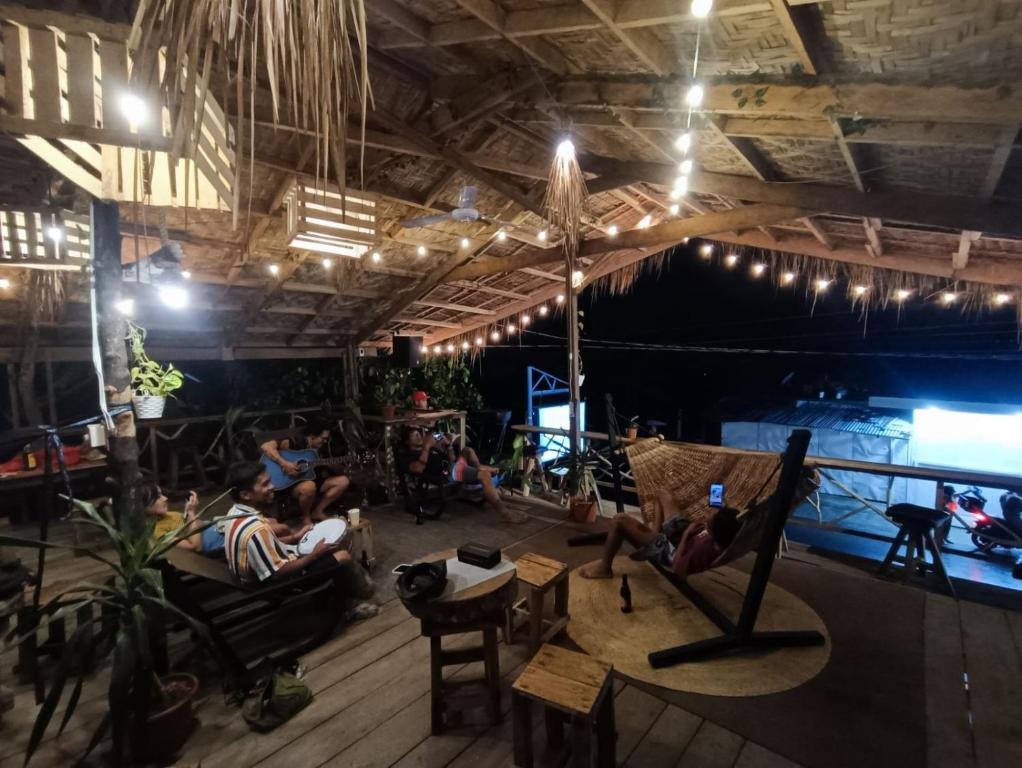 Relaxing rooftop lounge at Four Twenty Siargao with string lights and wooden seating